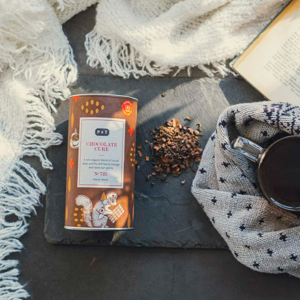 Braune Zylinderdose 'CHOCOLATE CURE' Tee von P & T, mit losen Teeblättern, dunkler Tee in gestricktem Becher, Buch.