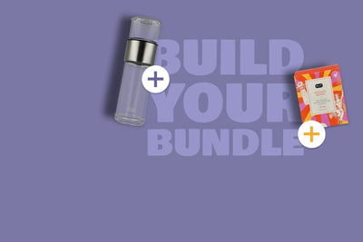 Klares Glasfläschchen und bunte P&T GOLDEN BOOST Teebox mit Kurkuma auf violettem Hintergrund.